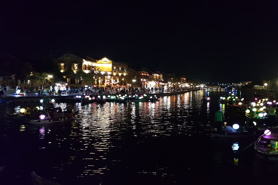 Lantern boats and their reflections on the river in Hoi An at night
